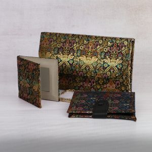 a brocade clutch purse with a matching mirror and card holder