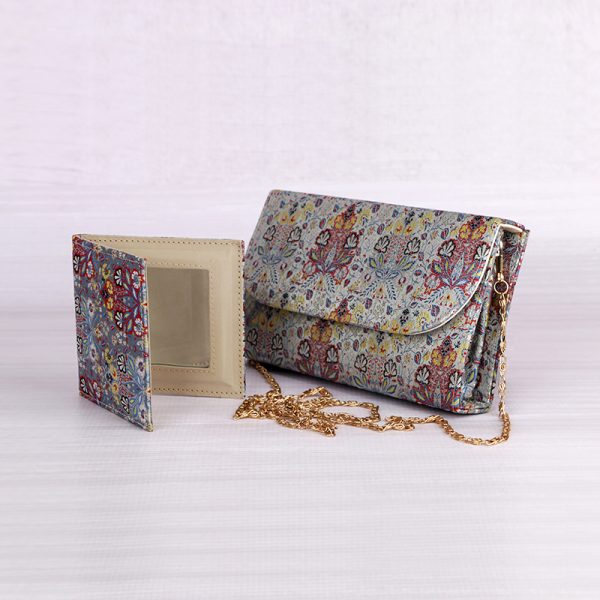 a brocade clutch purse with a matching mirror