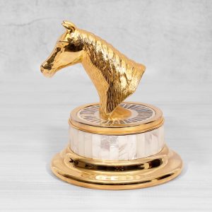 a gold-plated brass horse head trophy on a mother-of-pearl and gold base, symbolizing achievement and elegance