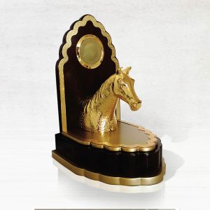 a gold-plated brass horse head trophy on a black and gold base, symbolizing achievement and elegance