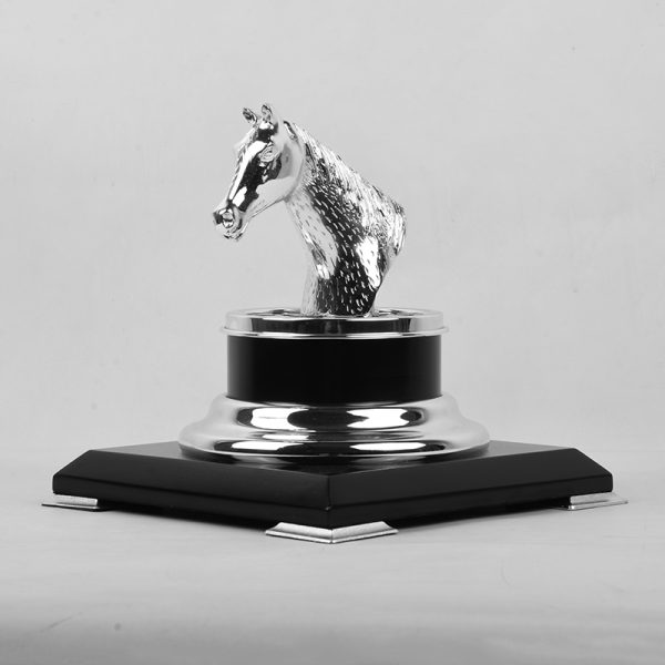 a silver-plated brass horse head trophy on a black and gold base, symbolizing achievement and elegance