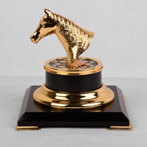 a gold-plated brass horse head trophy on a black and gold base, symbolizing achievement and elegance