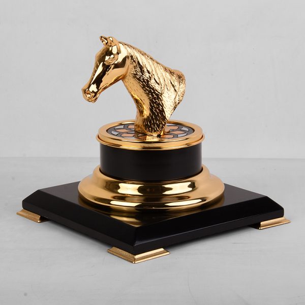 a gold-plated brass horse head trophy on a black and gold base, symbolizing achievement and elegance