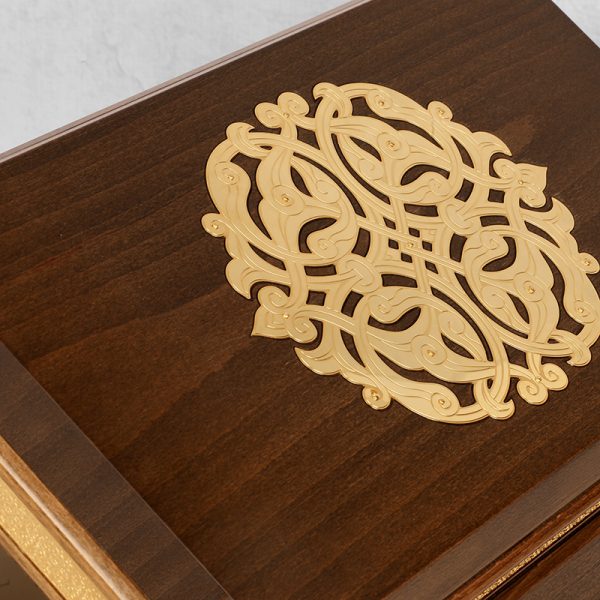 beautifully crafted dark wooden box with intricate gold-plated brass inlay designs, featuring an ornate lid and a light-lined interior.