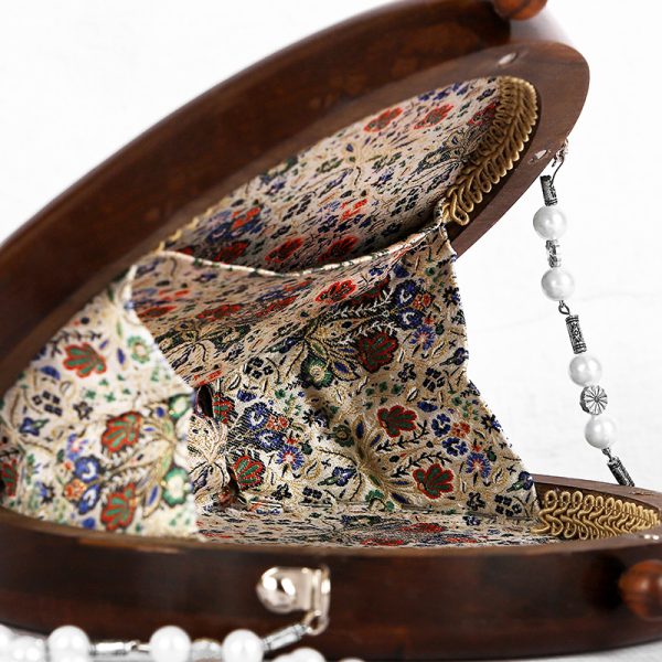 Handcrafted wooden box with intricate floral inlays and an elegant beaded handle.