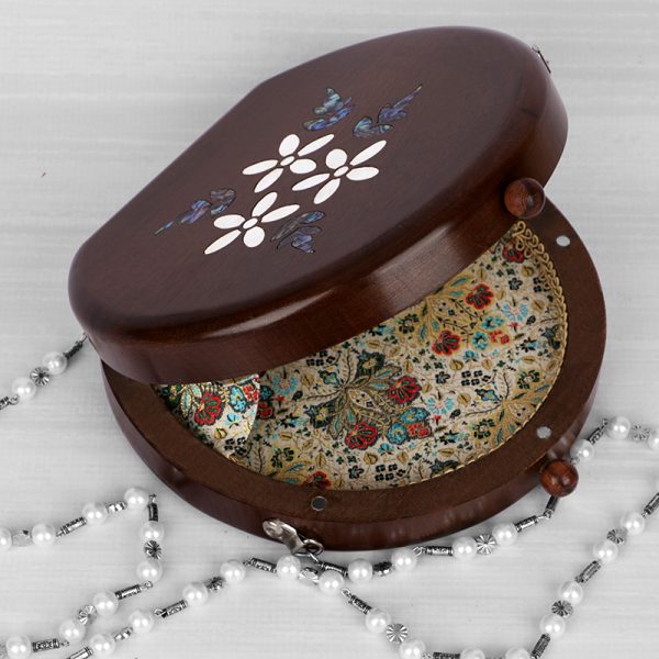 Handcrafted wooden box with intricate floral inlays and an elegant beaded handle.