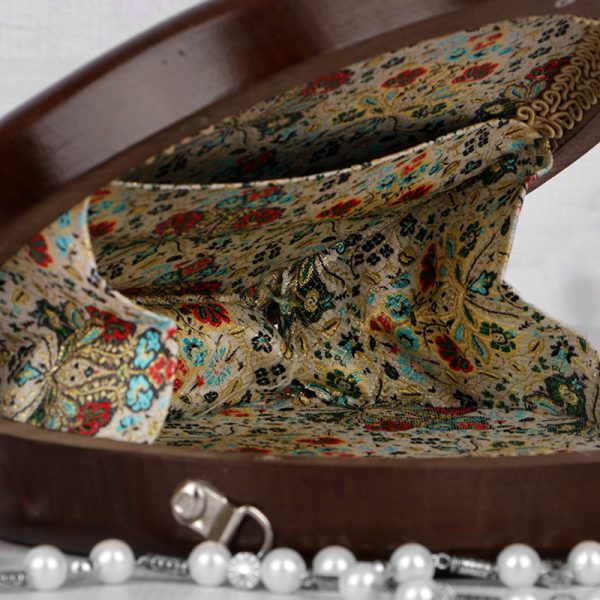 Handcrafted wooden box with intricate floral inlays and an elegant beaded handle.