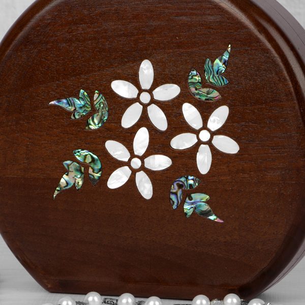 Handcrafted wooden box with intricate floral inlays and an elegant beaded handle.