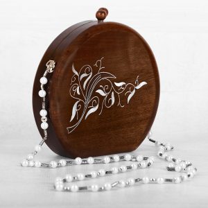 Handcrafted wooden box with intricate floral inlays and an elegant beaded handle.