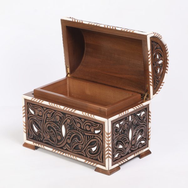 An intricately engraved walnut wood box, inlaid with mother-of-pearl and decorative bone.