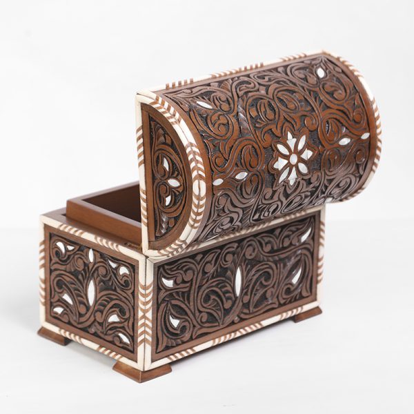 An intricately engraved walnut wood box, inlaid with mother-of-pearl and decorative bone.