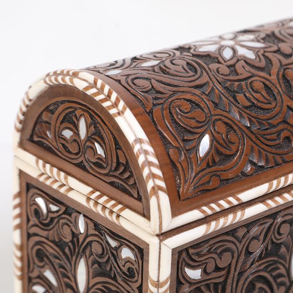 An intricately engraved walnut wood box, inlaid with mother-of-pearl and decorative bone.